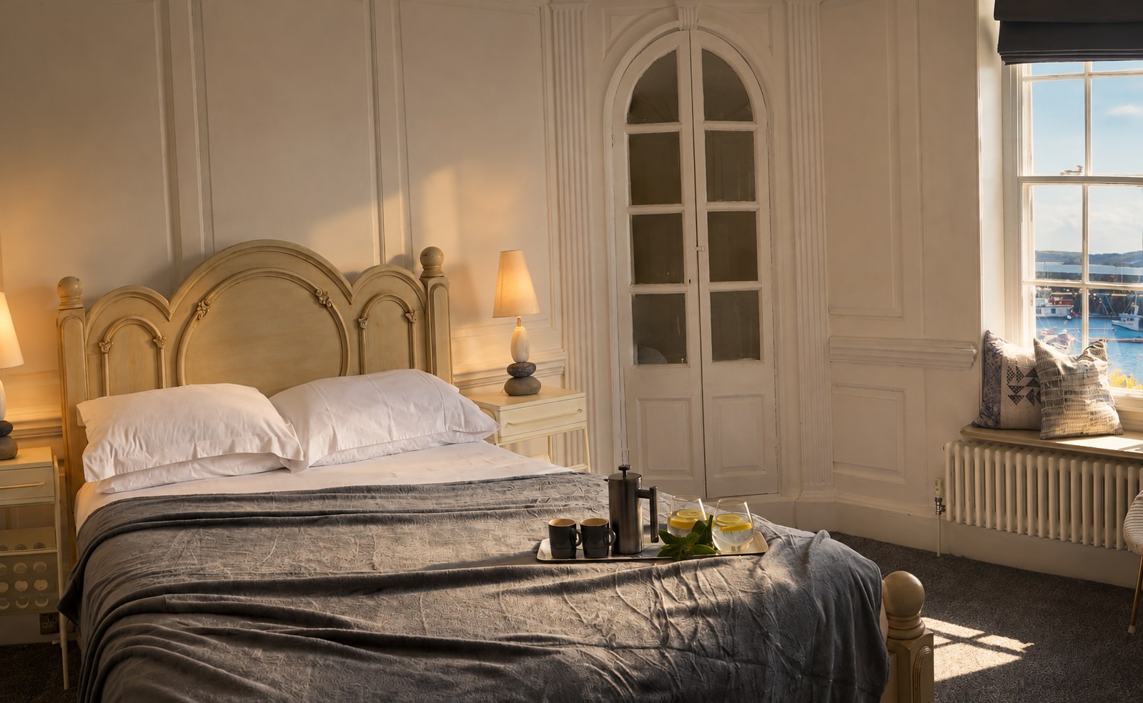White bedroom with arched sea-view windows